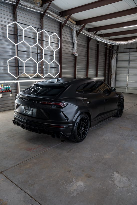 Satin black Lamborghini Urus rear three-quarter in our Lubbock TX shop